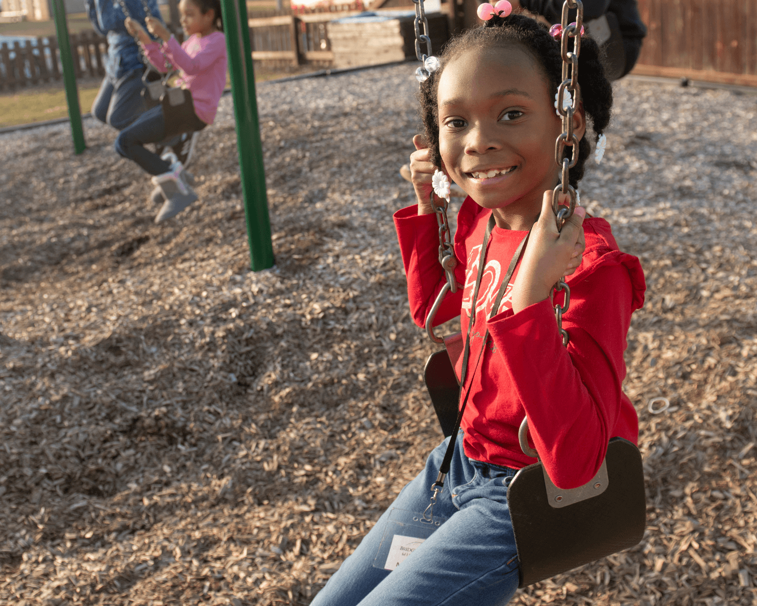 child swinging on a swing at Brewer Park